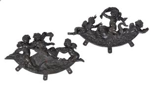 A pair of Continental patinated bronze figural mounts, late 19th century, relief cast, each