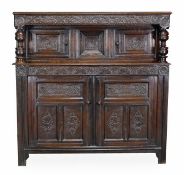 A Charles II oak press cupboard, circa 1670, rectangular top above a scroll and acanthus carved