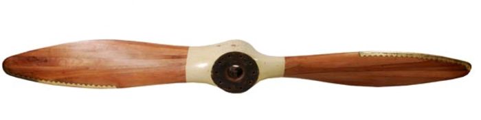 A fine laminated walnut two-blade pusher propeller, each blade with a scalloped brass strip leading