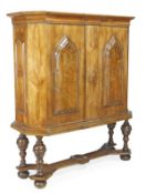 A German walnut cabinet, 18th century and later, with canted angles, moulded top and twin doors