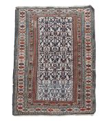 A Perpedril rug, decorated with ivory geometric motifs on a deep blue ground, geometric flowerhead