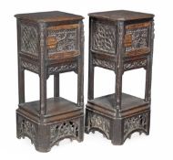 A pair of Victorian oak pedestal cupboards, circa 1880, rectangular top with canted corners, ornate
