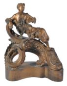A French gilt bronze chenet in the Rococo style, late 18th/early 19th century, surmounted by an