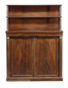 A Regency mahogany and gilt metal mounted side cabinet, circa 1815, upper shelves with turned