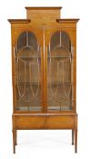 A satinwood and marquetry display cabinet, circa 1910, moulded cornice and floral decorated frieze,