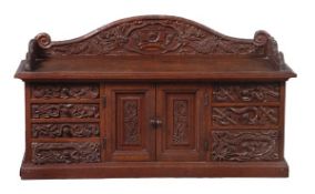 A carved and stained wood table cabinet, probably Anglo-Chinese, early 20th century, the three-