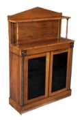 A Regency rosewood side cabinet, circa 1815, pedimented upper section with raised shelf, a pair of