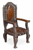 A Moroccan studded brown leather throne chair, circa 1900, of large proportions, with applied