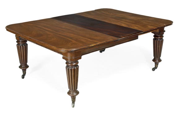 A Victorian mahogany extending dining table, circa 1870, with four additional leaf insertions in a