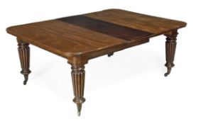 A Victorian mahogany extending dining table, circa 1870, with four additional leaf insertions in a