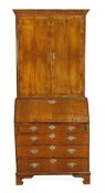 A George II walnut bureau bookcase, circa 1740, upper section with moulded cornice, pair of