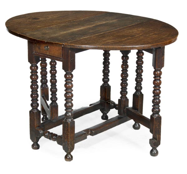 An oak gateleg table, circa 1690 and later, the hinged oval drop-leaf top, on bobbin turned legs