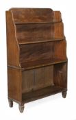 A Regency mahogany and ebony inlaid waterfall open bookcase, circa 1815, three quarter gallery with