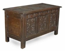 A Charles II panelled oak chest, circa 1660, triple panelled top and front, carved with stylised