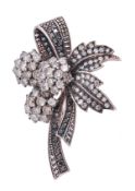 A diamond floral spray brooch, the brooch with three brilliant cut diamond clusters, to a black