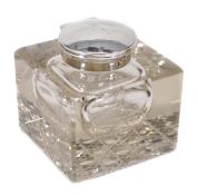 An Edwardian silver mounted clear glass cube inkwell by Walker & Hall, Sheffield 1903, with a plain