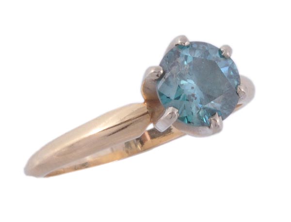 A single stone treated blue diamond ring, the brilliant cut diamond in a raised six claw setting,