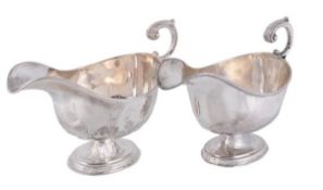 A pair of Edwardian silver oval pedestal sauce boats by Williams (Birmingham) Ltd, Birmingham 1904,