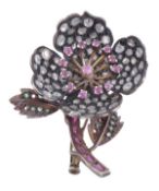 A gem set flower brooch, the brooch with rose cut diamond set petals, ruby set stamen and emerald