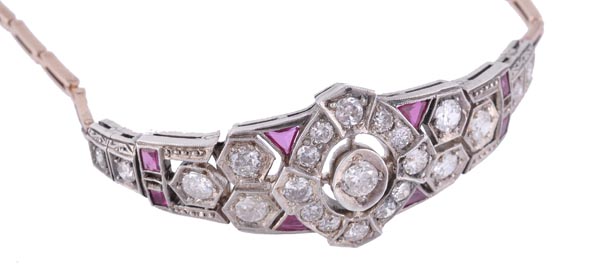 A diamond and synthetic ruby bracelet, the front of articulated pierced geometric panels set with
