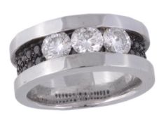 * A diamond and black diamond ring, the ring set with three brilliant cut diamonds, with black