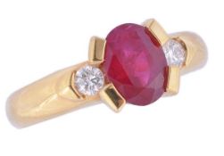 * A ruby and diamond ring, the ring centrally set with an oval cut ruby in a four claw setting