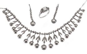 A diamond set necklace, ring and earpendants, the necklace of graduating foliate drops with old cut