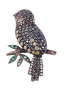 A gem set bird brooch, the bird set with black, yellow and white diamonds, sitting on a textured