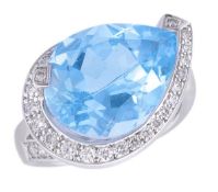 * A blue topaz ring, the ring set with pear shaped blue topaz in a spiralling surround of brilliant