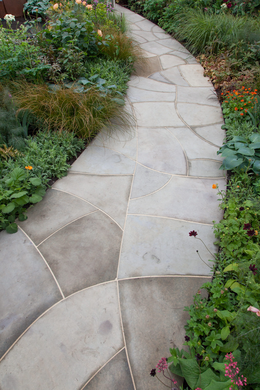*Crackle glaze stone pathCurved path and circular paved area in sawn Blackstone buff sandstone,