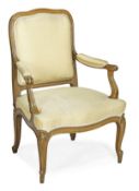 A French upholstered and carved beech fauteuil, early 20th century, padded backs, arm rests and