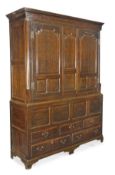 A George III oak housekeeper’s cupboard, circa 1780, probably North Wales, moulded cornice, pair of