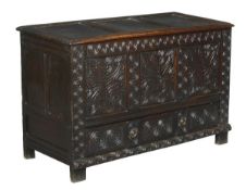 A carved oak mule chest, late 17th/early 18th century, hinged top, flower carved triple panelled