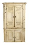 A George III pine standing corner cabinet, circa 1780, moulded cornice, two pairs of field panelled