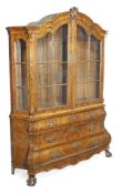 A Dutch burr walnut display cabinet, late 18th century style, first half 20th century, arched