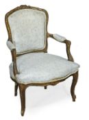 A French carved and giltwood upholstered fauteuil in Louis XV style, late 19th century, with