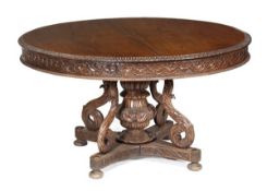 A Colonial hardwood centre table, circa 1860, circular top with lappet carved moulded edge, carved