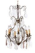 A wrought metal and glass hung six light chandelier in the Louis XV style, early 20th century, the