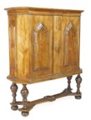 A German walnut cabinet, 18th century and later, with canted angles, moulded top and twin doors