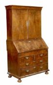 A George II walnut bureau bookcase, circa 1740, moulded top, pair of cupboard doors opening to