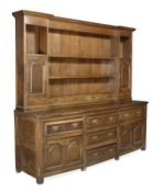A George III oak dresser, circa 1780, open plate rack incorporating cupboards, base with an