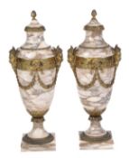 A pair of French gilt bronze and variegated cream marble mounted urns, late 19th century, each with