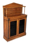 A Regency rosewood side cabinet, circa 1815, arched upper section with raised shelf, a pair of
