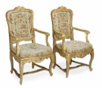 A pair of Italian carved giltwood and needlework upholstered armchairs, mid 18th century, each