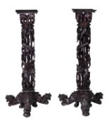 A pair of carved hardwood pedestal stands, late 19th/early 20th century, each square top above a