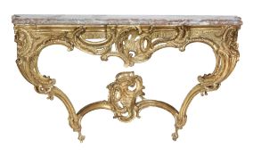 A Louis XV carved giltwood console table, circa 1750, of serpentine form, the mottled grey and