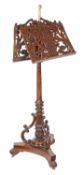 An early Victorian walnut duet stand, circa 1840, central brass stem with stylised acorn finial,