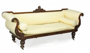 A George IV rosewood and upholstered settee, circa 1825, the rectangular back centred with a carved