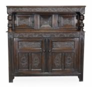 A Charles II oak press cupboard, circa 1670, rectangular top above a scroll and acanthus carved