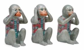 A group of three modern Chinese porcelain models of monkeys, seated on their haunches and in